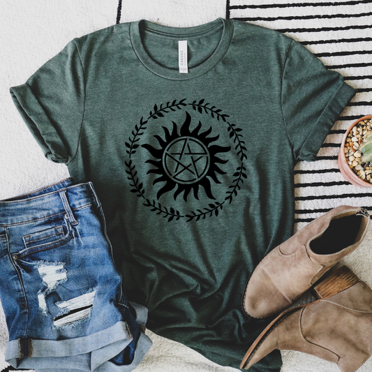 flat lay of an Anti Possession Symbol surrounded by a ring of Ivy on a heather forest shirt